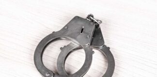 Suspect Captured – Deputy Marshal Killed A pair of metallic handcuffs resting on a light wooden surface
