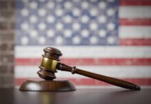 Lawyer Referred — Trump Case Implodes A wooden gavel resting on a sound block with an American flag background