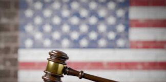 Lawyer Referred — Trump Case Implodes A wooden gavel resting on a sound block with an American flag background