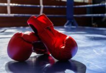 Road Rage? Boxer Killed After Shocking Move An empty boxing ring illuminated by bright lights in a sports arena