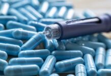 GLP-1 Twist Slashes Sick Leave Insulin pen on blue capsules