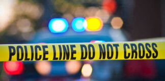 Parking Dispute Becomes Triple Homicide Police tape and lights at crime scene.