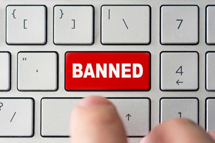 Red banned key on computer keyboard pressed
