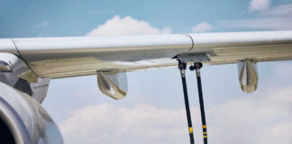 Scorching Runways, Empty Seats, Missed Flights Close-up of an airplane wing being fueled by a ground support truck