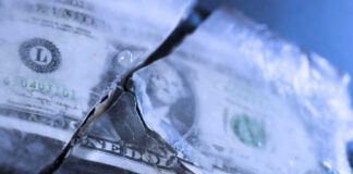 A dollar bill partially encased in ice
