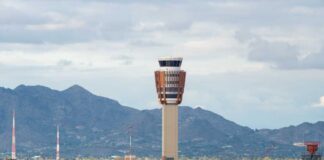 Airport control tower with mountains in the background