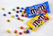 Candy Aisle Color Change M&M's candy bags with scattered colorful candies on a white table