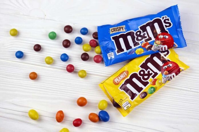 Kharkiv,,Ukraine,-,January,2,,2021,M,And,Ms,Colorful M&M's candy bags with scattered colorful candies on a white table
