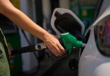 Person refueling a car at a gas station
