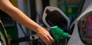 Pain At Pump Rattles Main Street Person refueling a car at a gas station