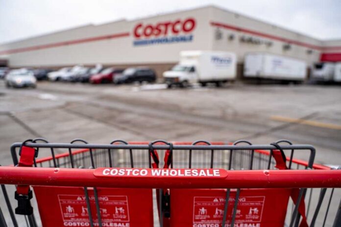 Close,Up,Of,Shopping,Cart,In,Front,Of,Costco,Wholesale Shopping cart in front of a Costco Wholesale store