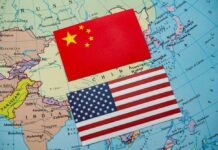 China and United States flags on a world map