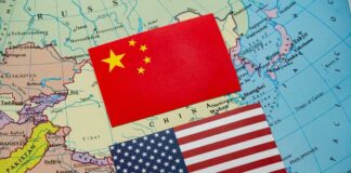 China and United States flags on a world map