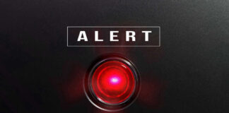 Dehydration Deaths Amid Exploding Outbreak Red alert light against black background, text ALERT.