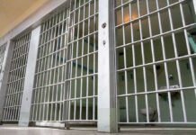 Judge Hammers Prisons Over THIS? Empty prison cell with metal bars and toilet.