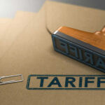 Crowd Roars As Trump Cuts THIS Tariff Folders with the word tariff stamped