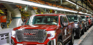 Red GMC pickup truck on an assembly line