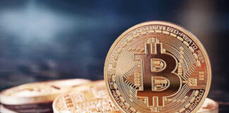 Bitcoin’s $85K Shock: Melt-Up Or Mirage? Bitcoin coins on a reflective surface.