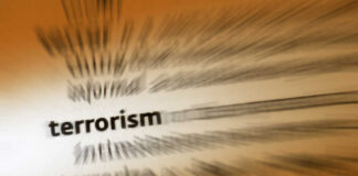Blurred text with the word 'terrorism' in focus