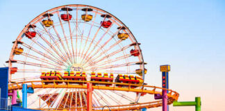Farewell Event Stuns Famed Hersheypark Colorful amusement park scene featuring a ferris wheel and roller coaster at sunset