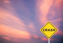 VIDEO: Nuclear Bomber Crashes Killing Crew Yellow crash warning sign against a pink and purple sunset sky