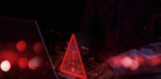 Terror Recruits Age 12 — Online! Warning symbol over laptop with user.