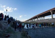 VIDEO: Incredible Horror As Towns Vanish In Mud Slide People crossing a shallow river near an overpass