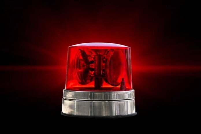 Red emergency beacon light on a dark background