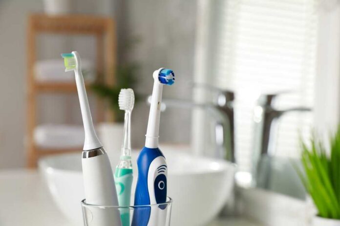 Electric,Toothbrushes,In,Glass,Holder,Indoors,,Closeup.,Space,For,Text