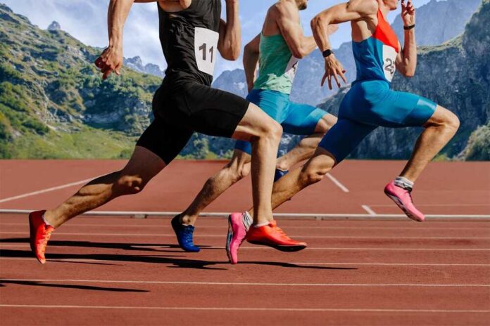 Group,Male,Athletes,Running,On,Red,Track,Stadium,On,Background Sprinters running on an outdoor track
