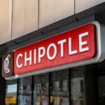 restaurant storefront sign with red panel and logo