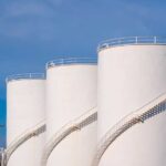 VIDEO: Diesel Shock – Half Refineries Crippled Large white industrial storage tanks with exterior spiral staircases