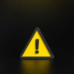 Deadly Seven-Year Mystery Located Yellow triangular warning sign with exclamation mark on black background