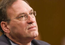 Samuel Alito in a close-up portrait wearing glasses