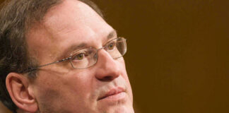 Samuel Alito in a close-up portrait wearing glasses