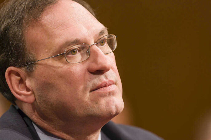 Samuel Alito in a close-up portrait wearing glasses