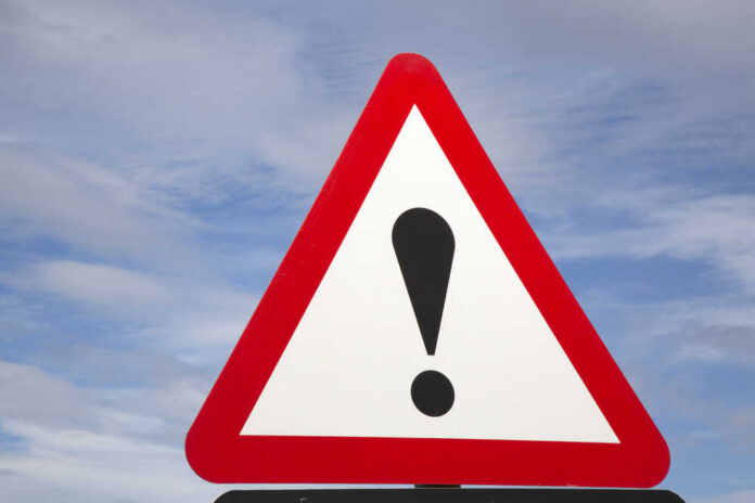 Exclamation,Mark,Traffic,Warning,Sign Warning road sign with exclamation mark against a cloudy sky