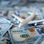Toy airplane on scattered US dollar bills
