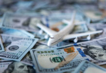 Toy airplane on scattered US dollar bills