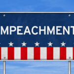 Sign displaying the word 'IMPEACHMENT' with a patriotic design