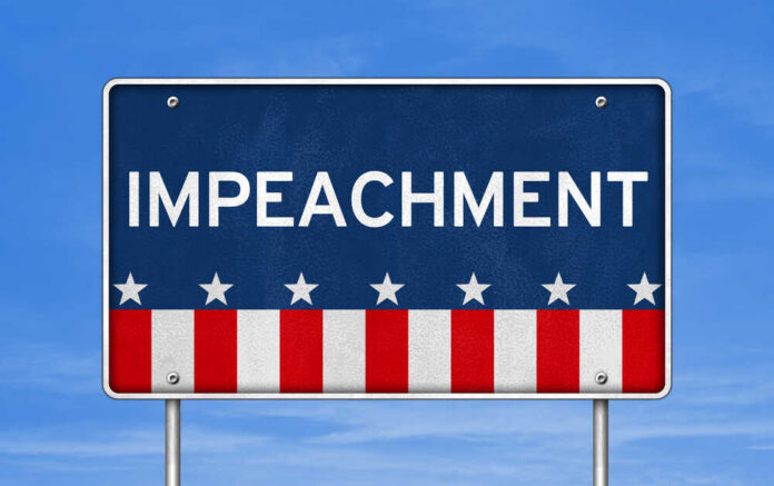 Sign displaying the word 'IMPEACHMENT' with a patriotic design