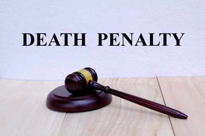 A wooden gavel resting on a block with the words 'DEATH PENALTY' in bold above it