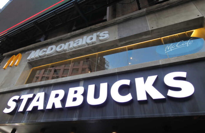 Signage for McDonald's and Starbucks in an urban setting