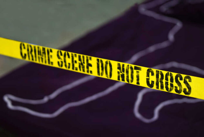 Yellow crime scene tape marking off an area with a chalk outline