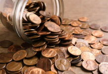 Bundles of cash next to a stethoscope and a note that says 'COST OF CARE'