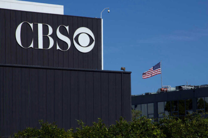 CBS building with American flag in background.