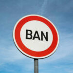 Supreme Court Targets Booze Ban Sign reading BAN against blue sky background
