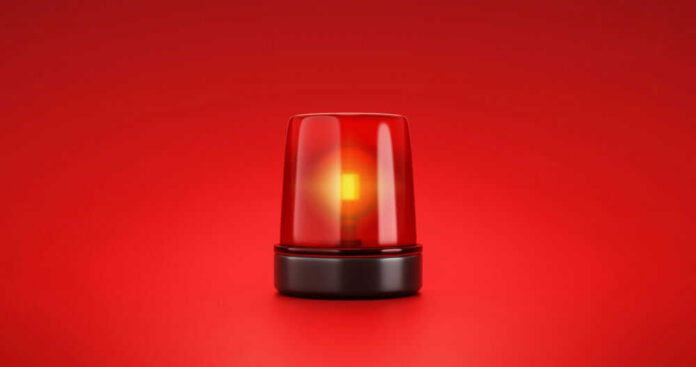 Red emergency light on red background