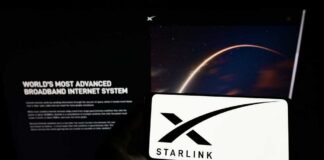 A smartphone displaying the Starlink logo in front of a screen showing a space image