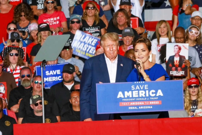 shutterstock_2212426151 Donald Trump at a rally with a woman speaking at the podium; Alexandros Papadiamantis, Margarita Stolbizer, and David Lowy are present in the crowd